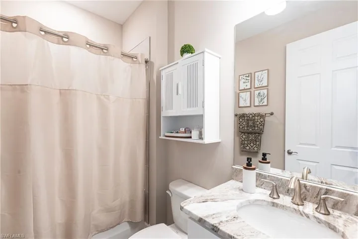 Full bathroom with vanity and toilet