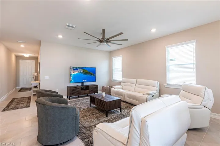 Living area featuring a ceiling fan, recessed lighting, light tile patterned flooring, and visible vents