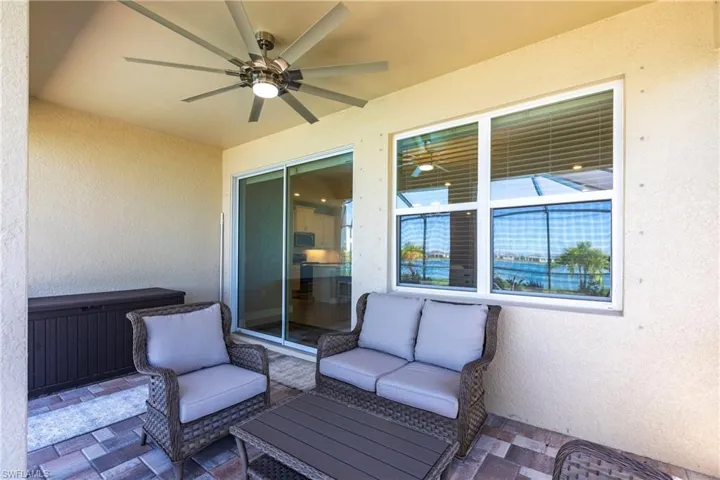 View of patio with an outdoor hangout area and ceiling fan