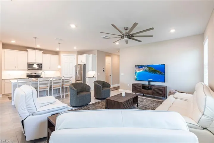 Living room featuring recessed lighting, baseboards, a ceiling fan, and light tile patterned flooring