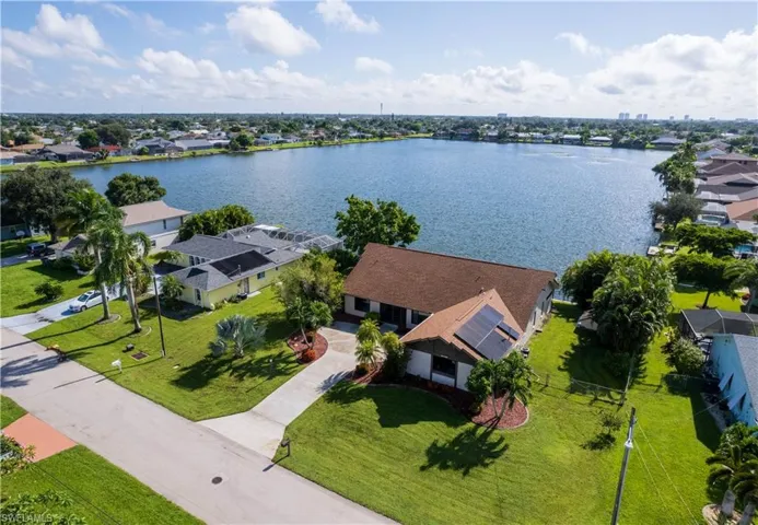 Birds eye view of property with a water view