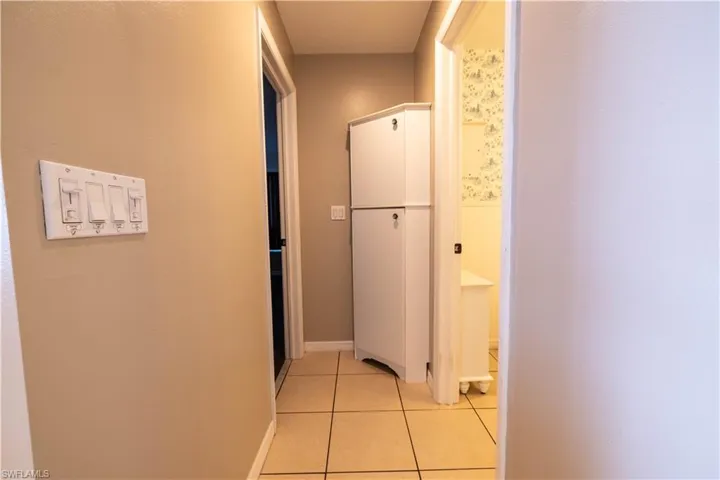 Hallway featuring light tile patterned floors