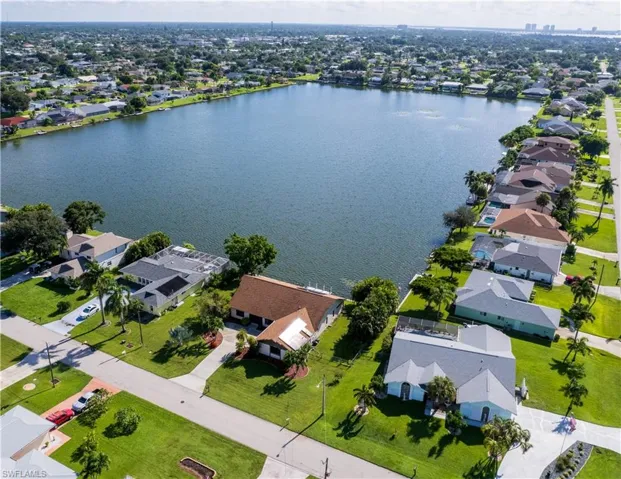 Birds eye view of property with a water view