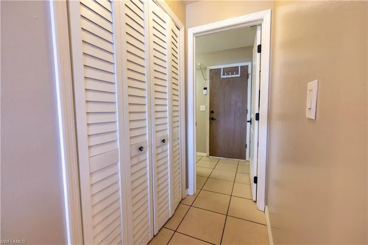 Hallway with light tile patterned flooring