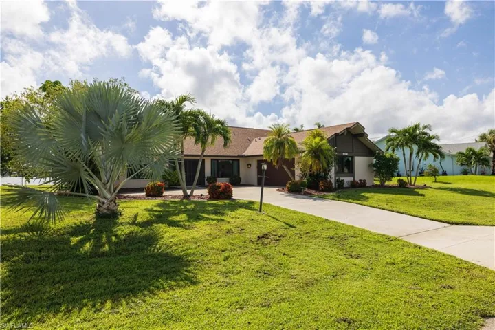 Single story home featuring a front lawn