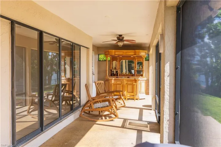 Sunroom with ceiling fan and sink