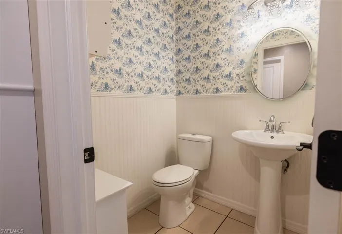 Bathroom featuring toilet and tile patterned flooring