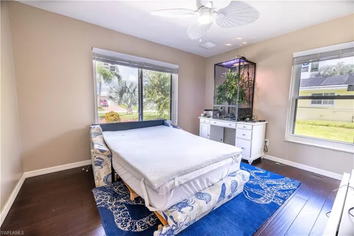 Bedroom featuring dark wood-type flooring and ceiling fan