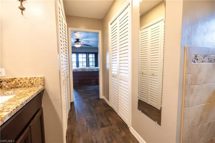 Corridor featuring dark wood-type flooring