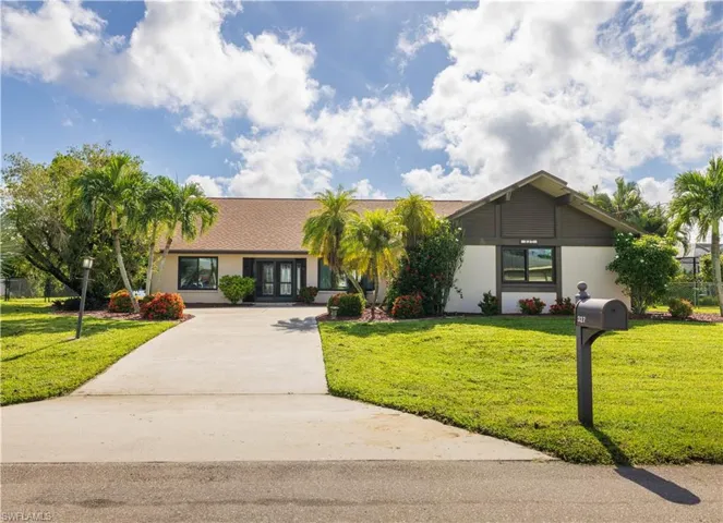 Single story home featuring a front lawn and french doors