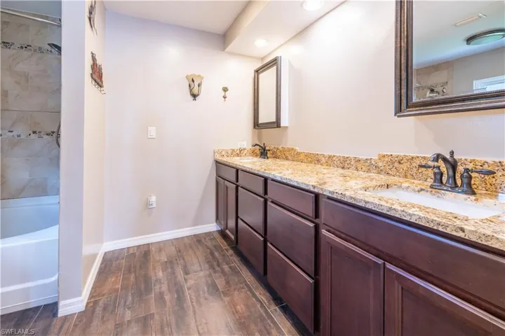 Bathroom featuring vanity, hardwood / wood-style floors, and independent shower and bath