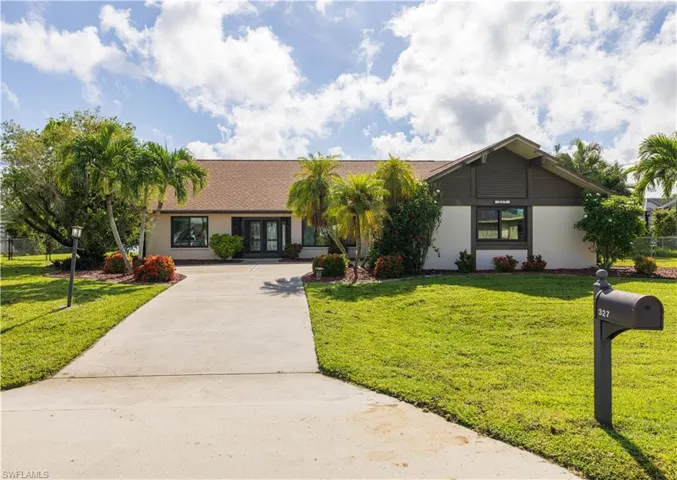 Ranch-style home featuring a front yard
