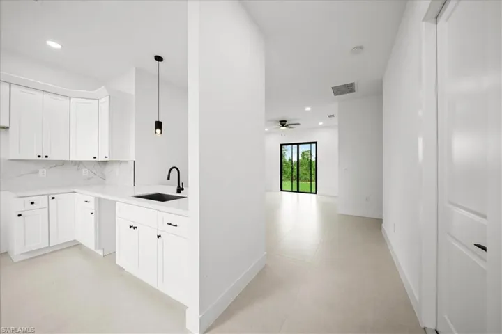 Corridor with recessed lighting and a sink