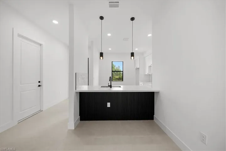 Bathroom featuring light tile patterned flooring, vanity, and recessed lighting