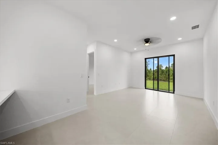 Spare room featuring recessed lighting, ceiling fan, and light tile patterned floors