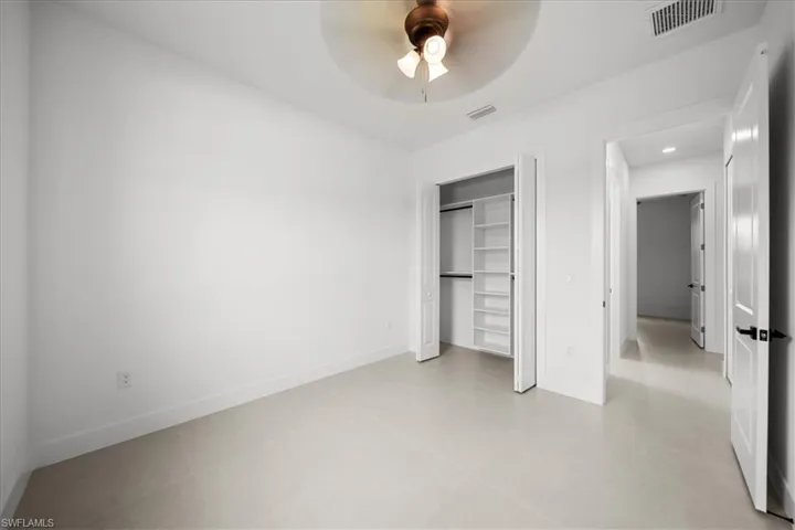 Unfurnished bedroom featuring a closet and a ceiling fan