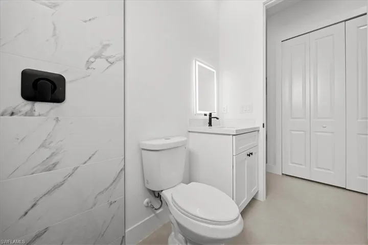 Bathroom featuring vanity and a closet