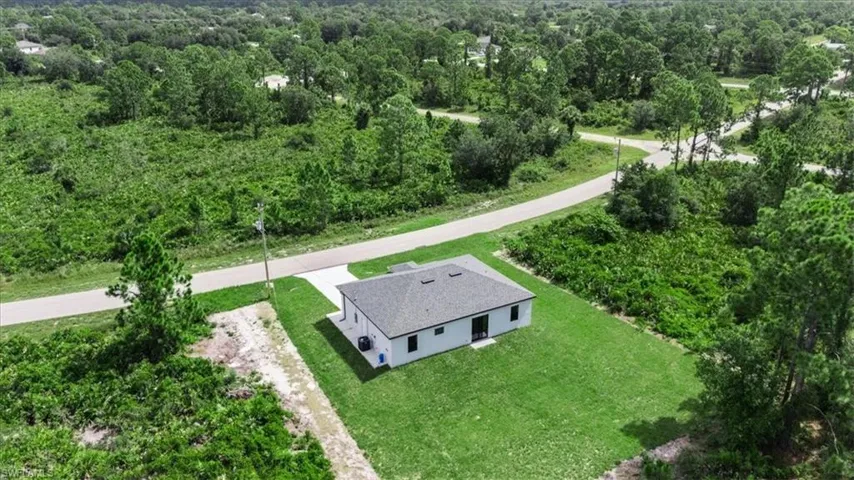 View of subject property featuring a heavily wooded area