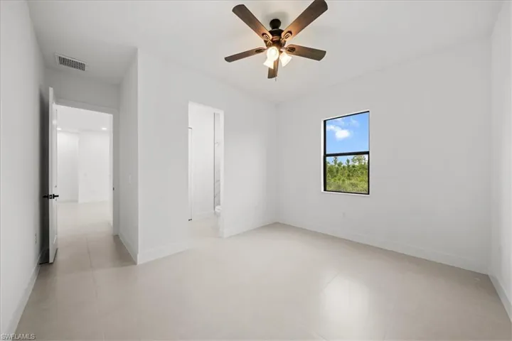 Unfurnished bedroom with baseboards and a ceiling fan