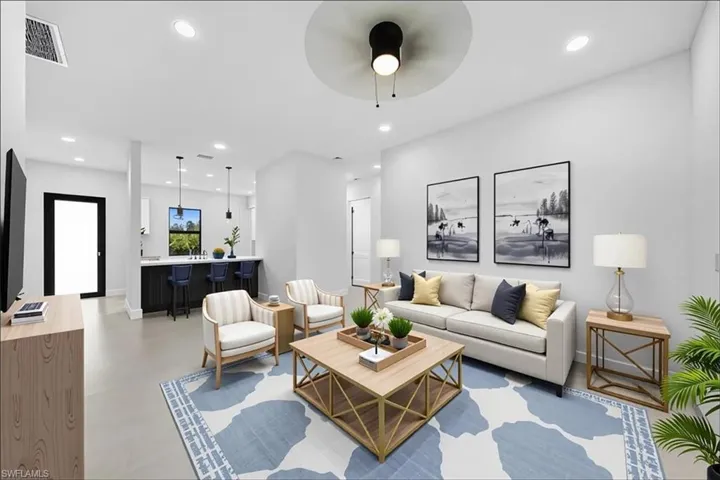 Living area featuring recessed lighting, a ceiling fan, and concrete flooring