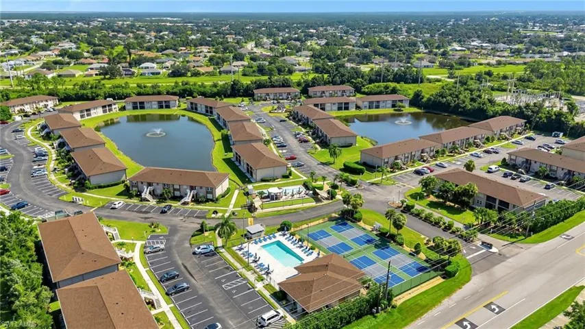 Bird's eye view of a nearby body of water and a pool