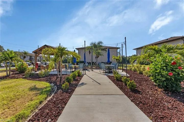 View of community with a patio and outdoor dining area
