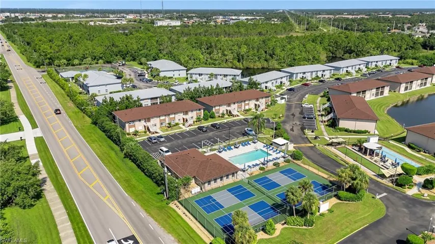 Aerial view of a pool area and a large body of water