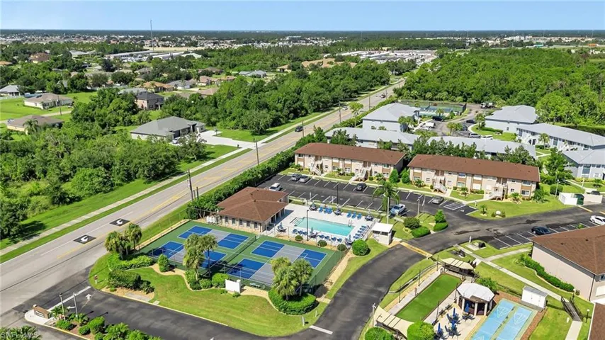 Aerial view of a tree filled landscape and a pool