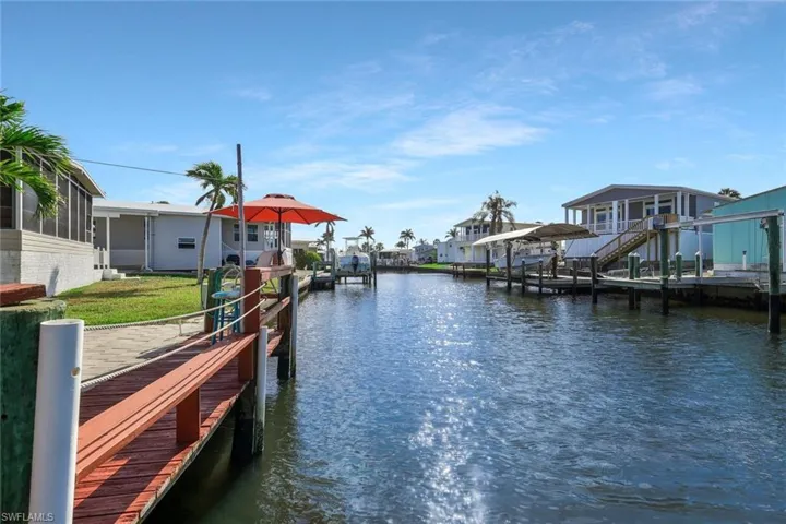 View of dock with boat lift and a water view
