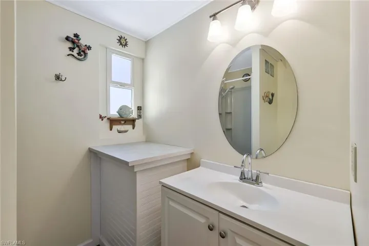 Full bath featuring visible vents, walk in shower, and vanity