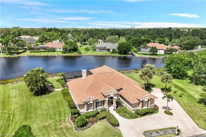 Birds eye view of property with a water view