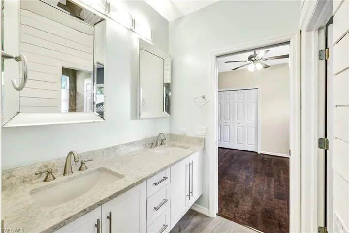 Bathroom featuring vanity, hardwood / wood-style floors, and ceiling fan