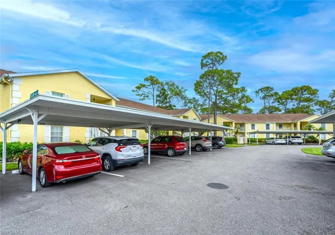 View of parking / parking lot with a carport