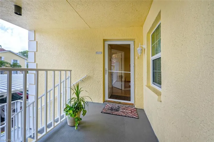 View of exterior entry featuring a balcony