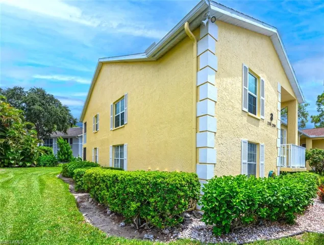 View of property exterior featuring a lawn