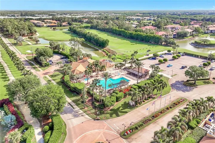 Aerial view featuring a water view and golf course view