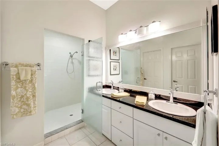 Full bathroom with tile patterned floors, a sink, and a tile shower
