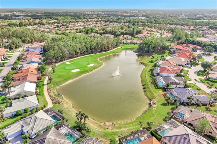 Drone / aerial view with view of golf course, a residential view, and a water view