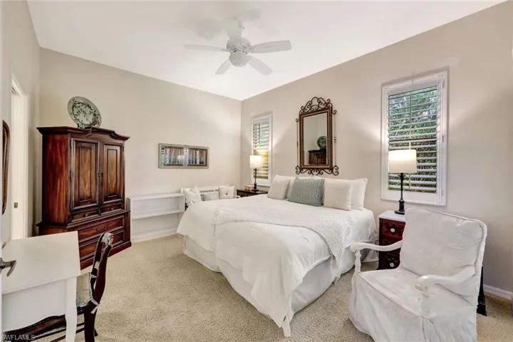 Bedroom with ceiling fan and carpet flooring