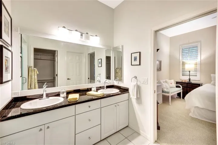 Full bath with double vanity, a closet, tile patterned flooring, and a sink