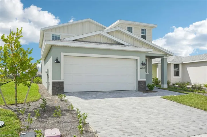Craftsman house featuring a front lawn and a garage