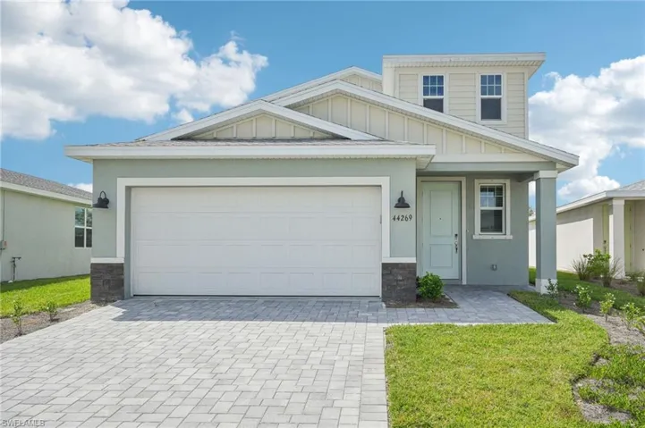 Craftsman house with a garage and a front yard