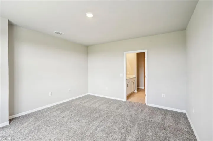 Spare room featuring light colored carpet