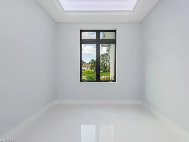 Empty room with a raised ceiling and baseboards