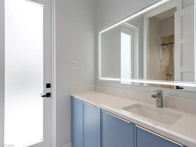 Bathroom featuring walk in shower and vanity