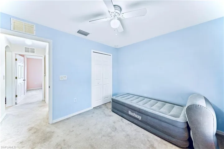 Bedroom with visible vents, a closet, and carpet flooring