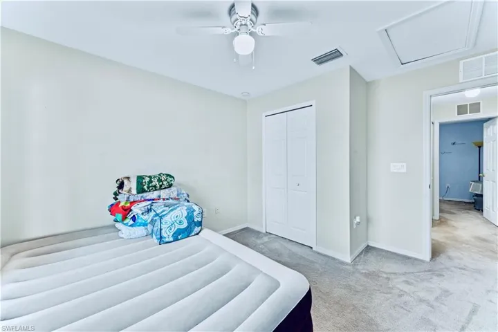 Bedroom with visible vents, baseboards, and light colored carpet