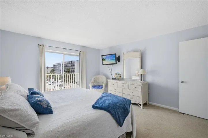 Master Bedroom featuring carpet flooring, access to outside, and a textured ceiling