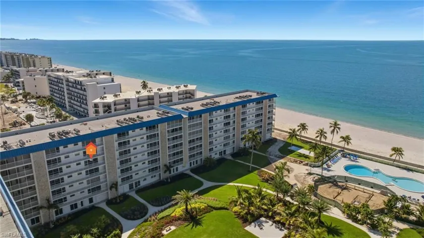 Bird's eye view of apartment complex / building and unending shoreline