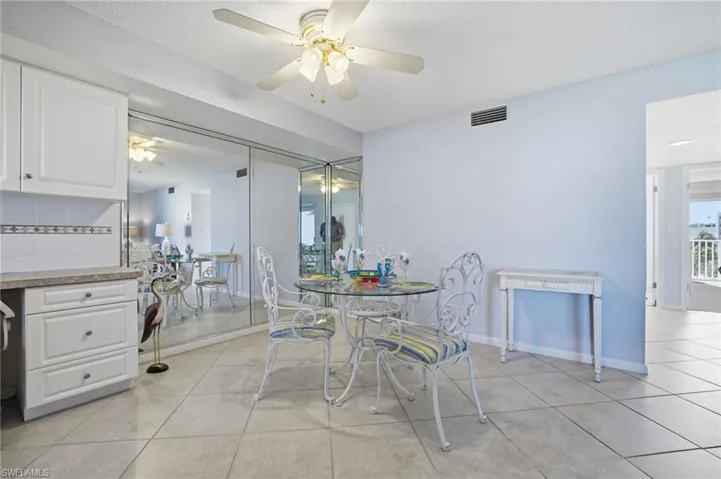 Dining space featuring light tile patterned floors and a ceiling fan